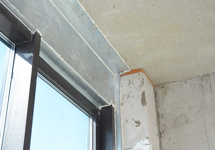 A balcony glass door, window is installed with a metal steel lintel, metal construction, panel above, connecting the ceiling and the balcony door.